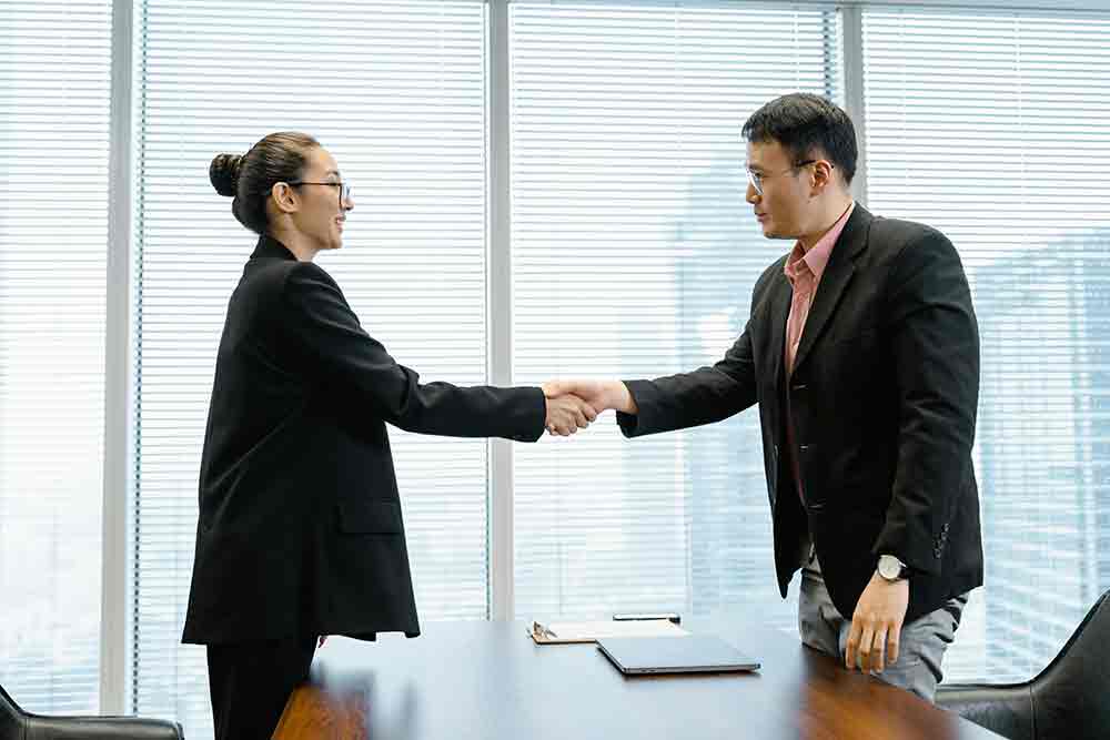 asian woman cpa accountant shaking hands with client in toronto